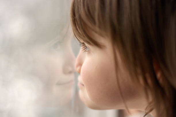 istock Cute little girl looking through window 1508830975