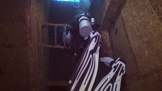 Scuba diver swim inside of ferry Salem Express shipwreck, Red sea, Safaga, Egypt