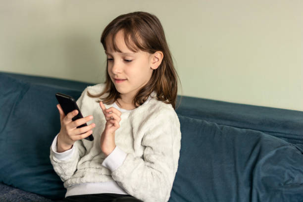 istock Girl using mobile phone at home 1508832625