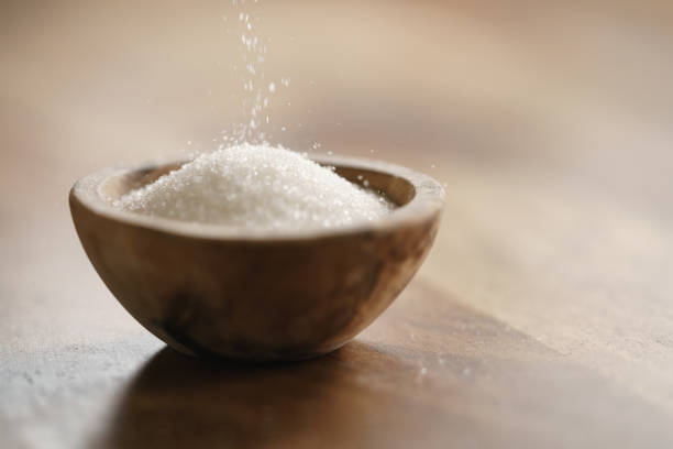 istock sugar pour in wood bowl on wooden table 1508846635
