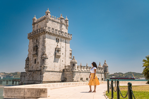 Woman in front of Torre de Belem in Lisbon, Portugal
