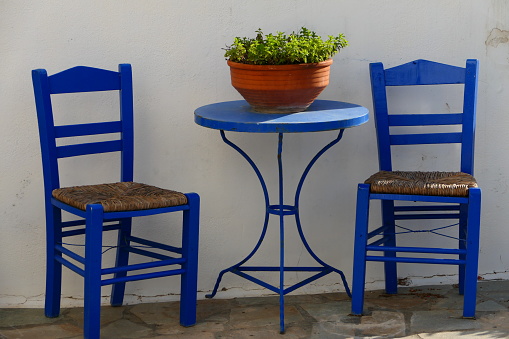 Greek shot, bistro table and two chairs in the village of Chora, the capital of Kythera, Greece