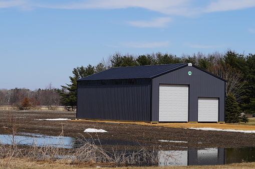 Large metal black storage unit sits on roadside.