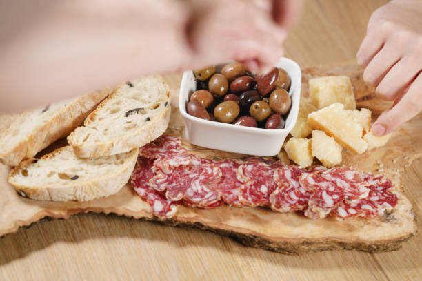 istock hands taking italian antipasti appetizers on table 1508907709