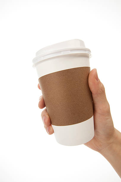 istock One hand holding white coffee cup with brown cup holder 150891341