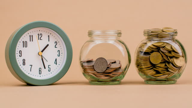 saving money coin in glass jar time of saving money doing business investment accumulation of financial assets income salary financial planning time management money and valuable time savings concept