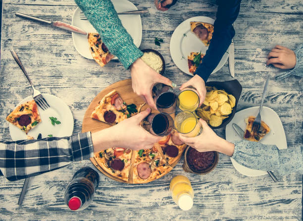 istock people clanging glasses together having pizza 1508926706