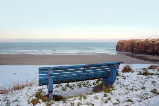 ballybunion bench in winter with view of beach and cliffs