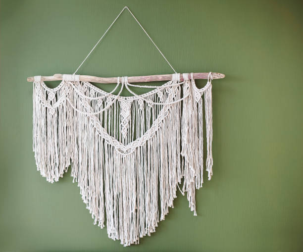 istock White handmade macrame decoration hanging on green wall, bohemian style decorative item 1508928375