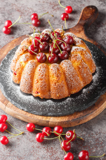 istock Freshly baked cherry cake close-up on a wooden board. Vertical 1508942502