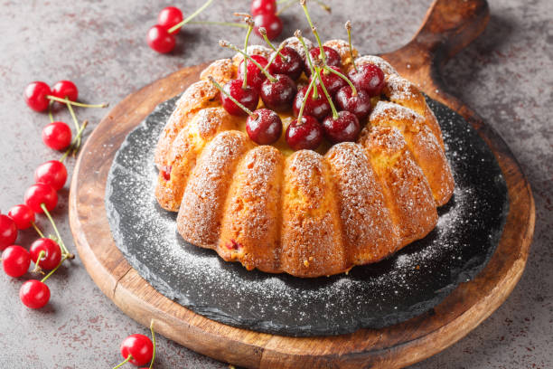 istock Delicious biscuit vanilla cherry bundt cake decorated with fresh berries and powdered sugar close-up on a wooden board. Horizontal 1508943017