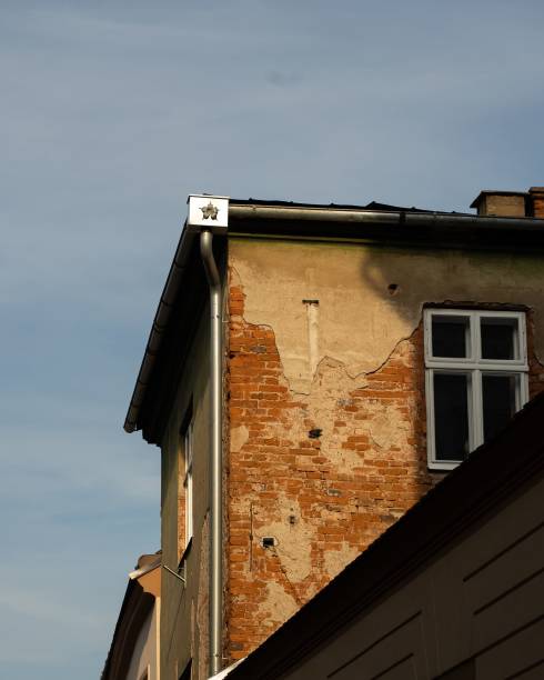 istock Closeup  of a historic structure featuring multiple windows and sculptures atop its roof 1508961276