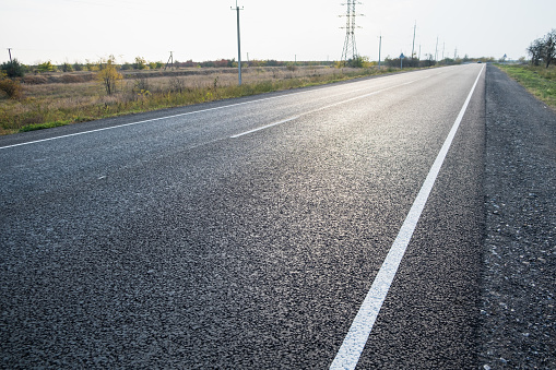 black asphalt road and white dividing lines. download photo