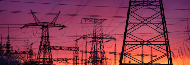 View of high voltage pole power transmission tower on sunset. Panorama high voltage tower with power lines.