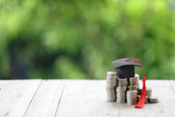 istock Knowledge and Success: Graduation Cap on Books Against a Beautiful Nature Background. Achievement Unlocked: Graduation Cap and Books Symbolize Education Savings and Academic Growth. 1508977211