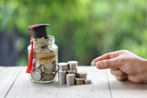 istock Knowledge and Success: Graduation Cap on Books Against a Beautiful Nature Background. Achievement Unlocked: Graduation Cap and Books Symbolize Education Savings and Academic Growth. 1508977243