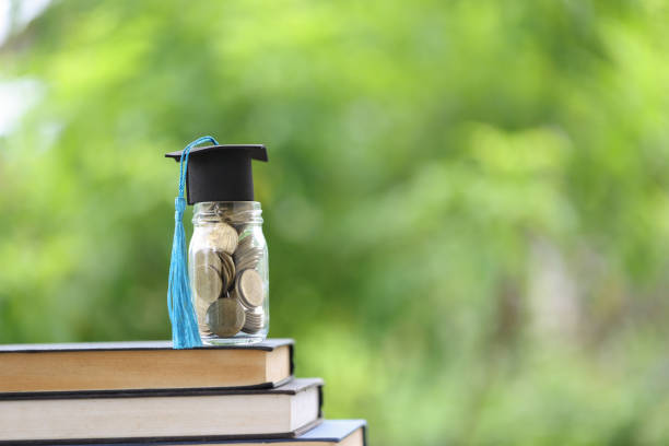 istock Knowledge and Success: Graduation Cap on Books Against a Beautiful Nature Background. Achievement Unlocked: Graduation Cap and Books Symbolize Education Savings and Academic Growth. 1508977321