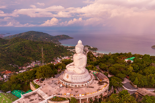 Phuket white Big Buddha statue at morning sunrise. The landmark of Thailand. Copy space over the sky.