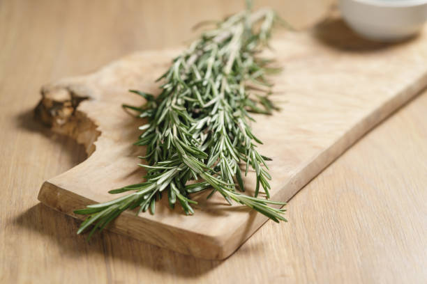 istock fresh rosemary bunch on wood table 1509004470