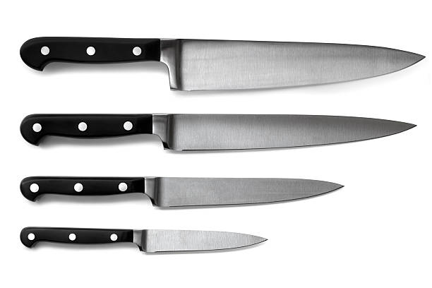 Set of Kitchen Knives Isolated Set of steel kitchen knives, isolated on white with soft shadows. Includes carving, paring, and utility knives. kitchen knife photos stock pictures, royalty-free photos & images