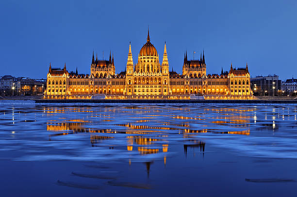 Hungarian parliament at dusk Parliament at dusk, Icy Danube River, Budapest, Hungary blue danube stock pictures, royalty-free photos & images