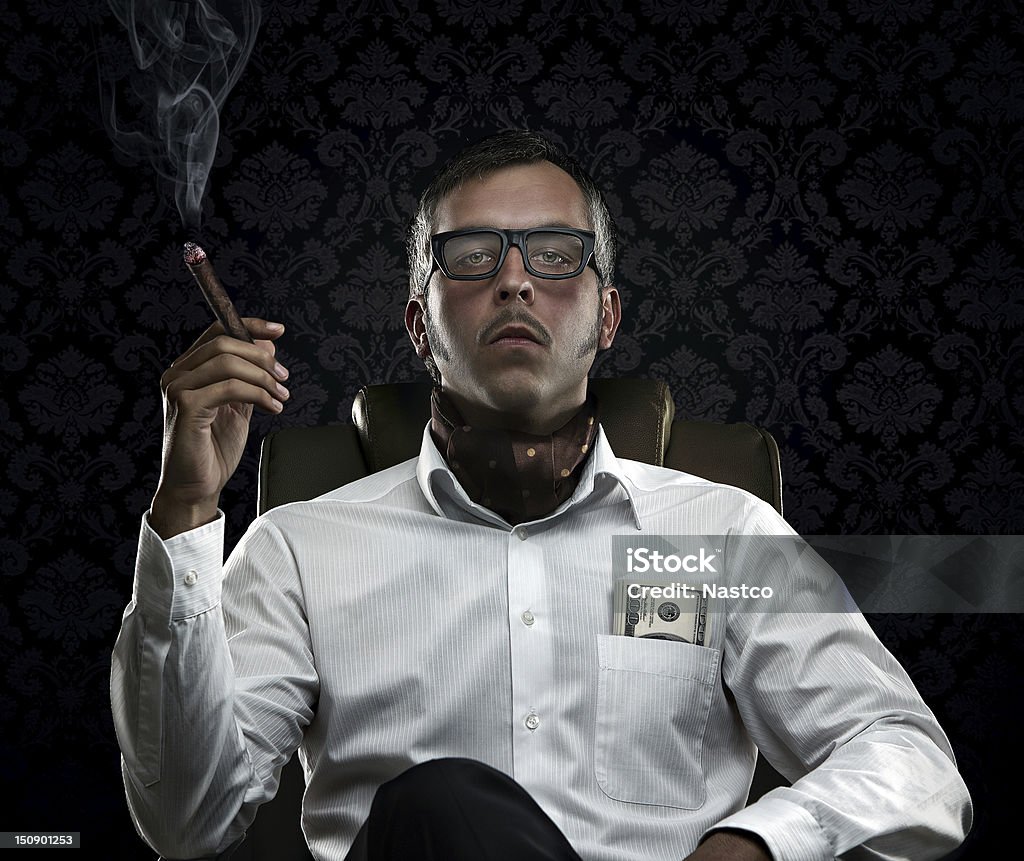 Portrait of serious rich man with money and cigar Funny portrait of rich man with serious face expression smoking cigar Currency Stock Photo