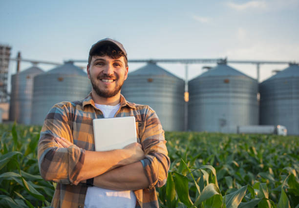istock Portrait of smiling farmer working with technology in corn field. 1509014093