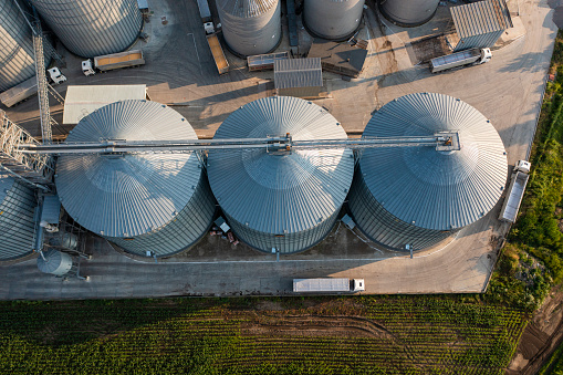 Aerial shot of silos next to corn fields.