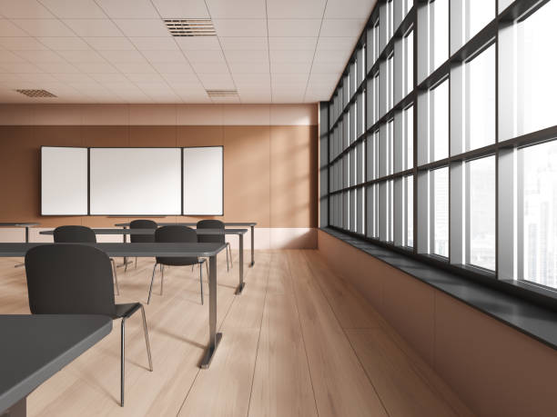 istock Stylish new classroom interior with desk and mockup chalkboard near window 1509023027