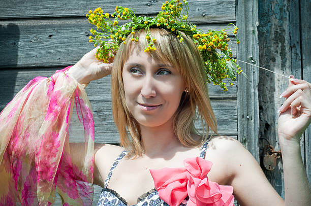 the beautiful girl with a wreath from wild flowers on the head