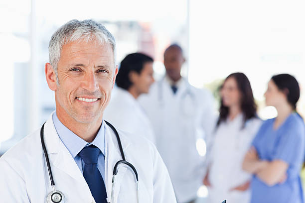 istock Mature doctor standing upright while waiting for his team 150906222