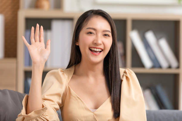 istock Camera first view Beautiful Asian young woman talking and introducing myself via video conference call smile at home. Portrait happy teacher coach looking at camera online class or vlogger recording 1509080925