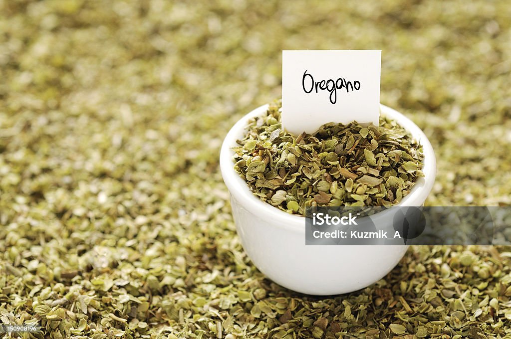 Oregano Dried oregano in a white ceramic bowl Bowl Stock Photo