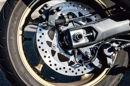 The rear wheel of a powerful sports motorcycle.