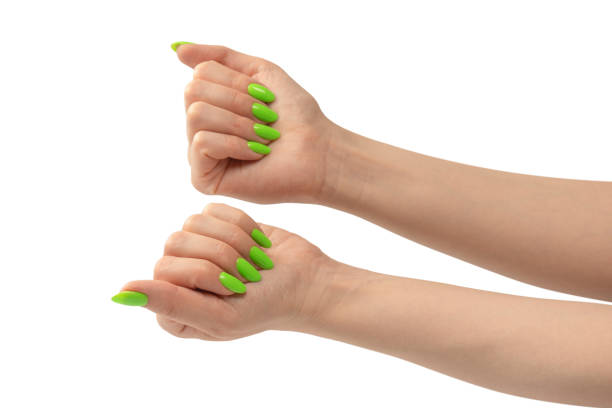 istock Hand of a woman with green naols hold some tiny or thin object. 1509123079