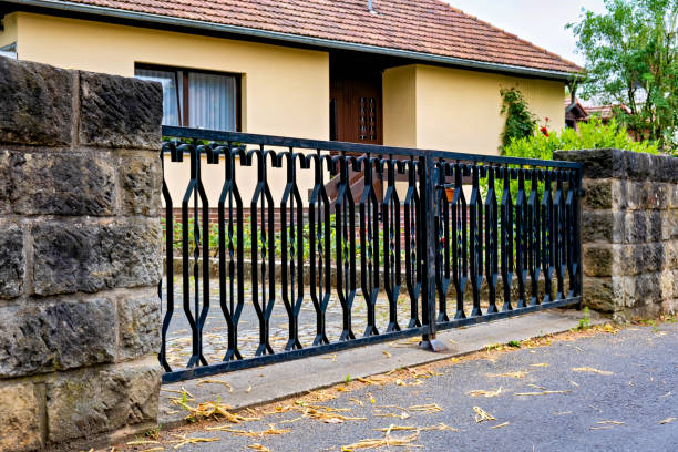 istock A black iron gate with stone pillars in front of a house in Germany 1509152025