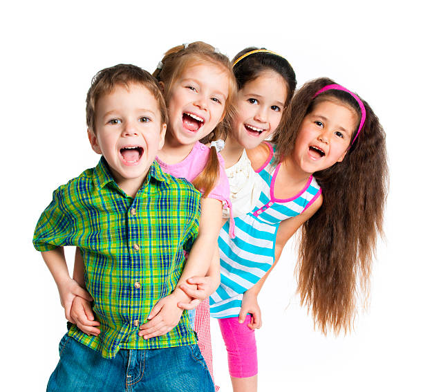 portrait of young happy and excited child smiling and laughing cheerful wearing yellow t-shirt isolated on white background in kid happiness and joyful face expression concept