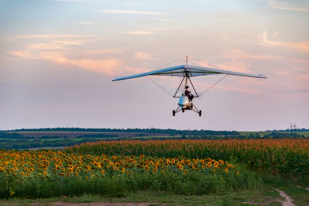 istock White motorized hang glider flies above sunflower field 1509165415