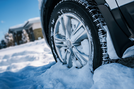 Car wheel in snow at winter season