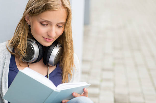 istock Student reading a book outside of university 150917779