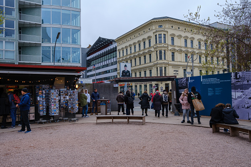 Berlin, Germany - April 19, 2023 : View of an outdoor exhibition of the famous Checkpoint Charlie, the crossing point between East Berlin and West Berlin Germany