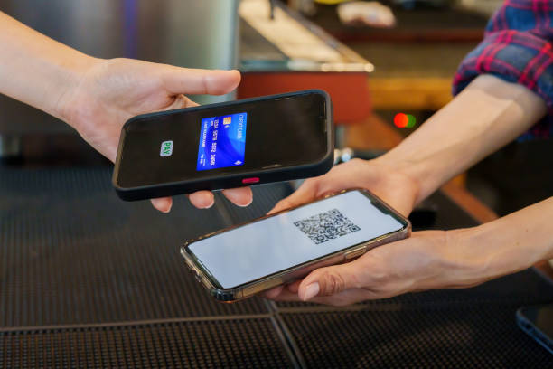 istock Bakery worker standing on phone with QR code for payment account Customers who want to pay by transfer Customers hand over their phones by scanning a QR code to pay by credit card. check mark screen 1509200889