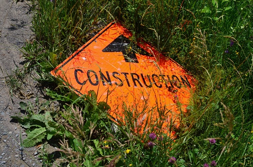 fallen construction sign in the grass