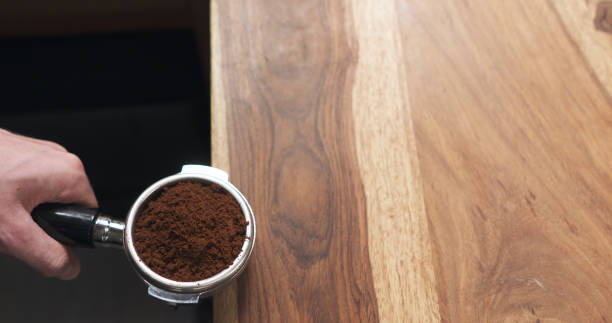 istock man hands tamping fresh ground coffee from above 1509206890