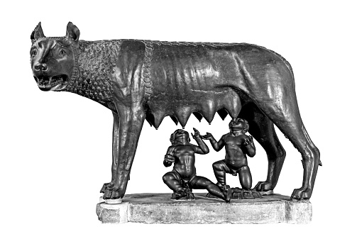 Capitoline she-wolf or Lupa Capitolina, a bronze figure showing Romulus and Remus, the mythical founders of the city of Rome in Italy, black and white isolated on white sculpture