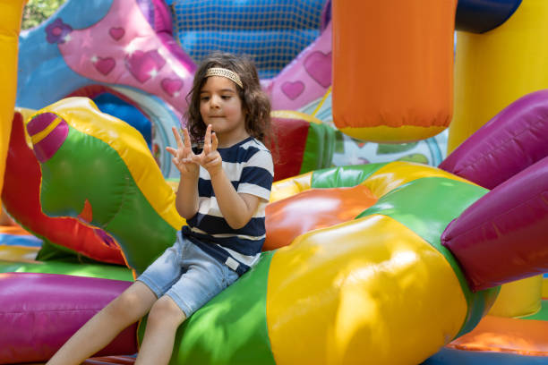 Little boy is playing in bouncy castle.
