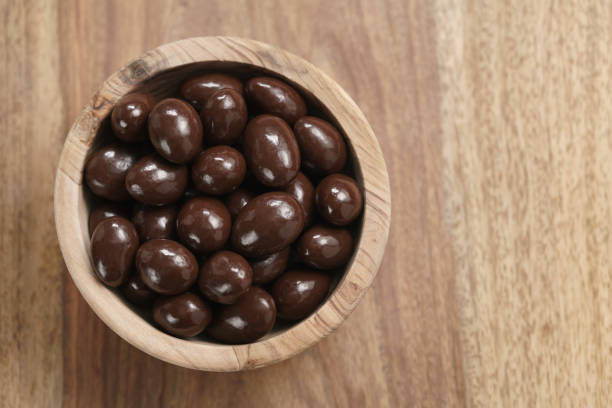 istock chocolate covered almonds in wood bowl on table 1509249486