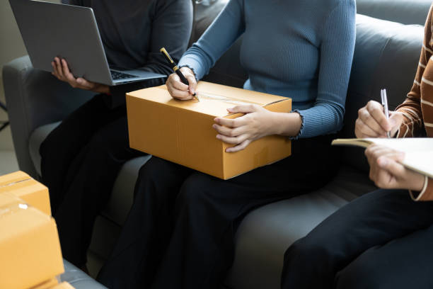 istock Asian small business owners who work at home with parcel boxes and laptops take note of orders. Packaging delivery, online marketing, start-up SME entrepreneurs or independent women concepts. 1509253325