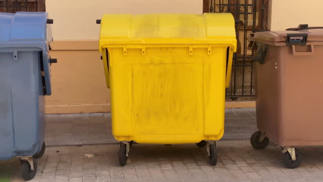 Plastic garbage bins in the street
