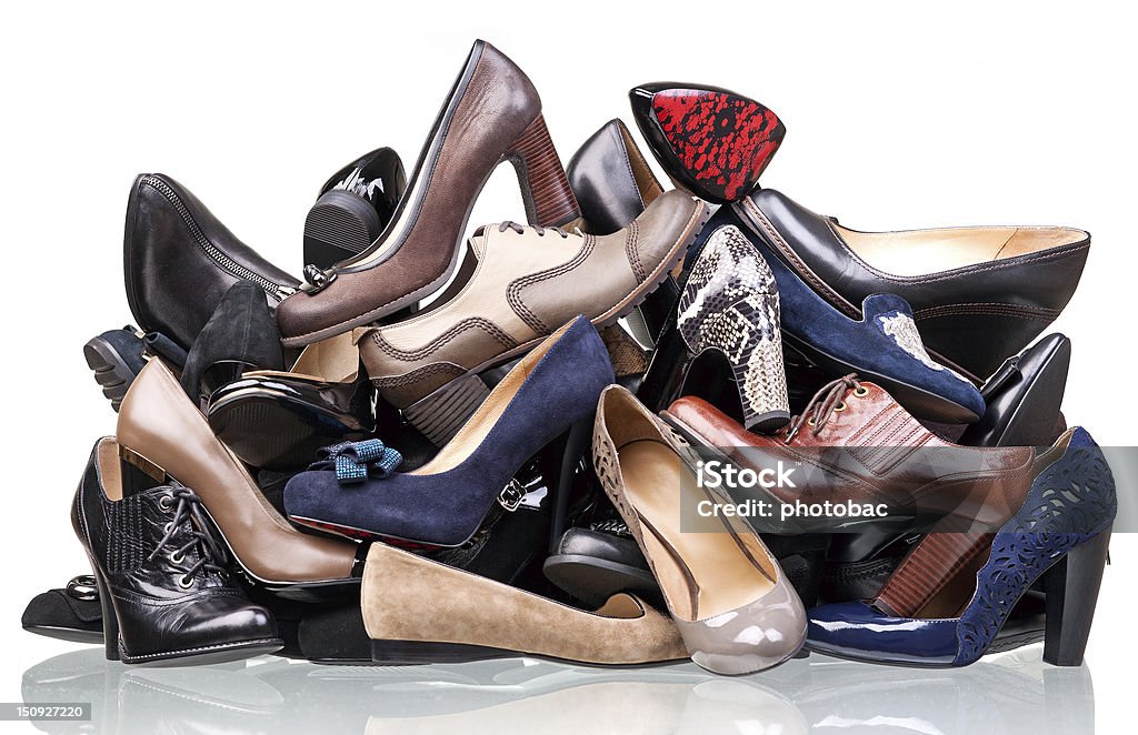 Pile of various female shoes isolated over white Pile of various female shoes isolated over white background Shoe Stock Photo